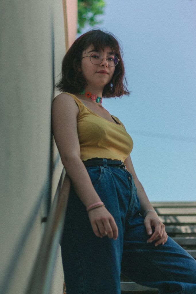 woman standing on stairs leaning on wall