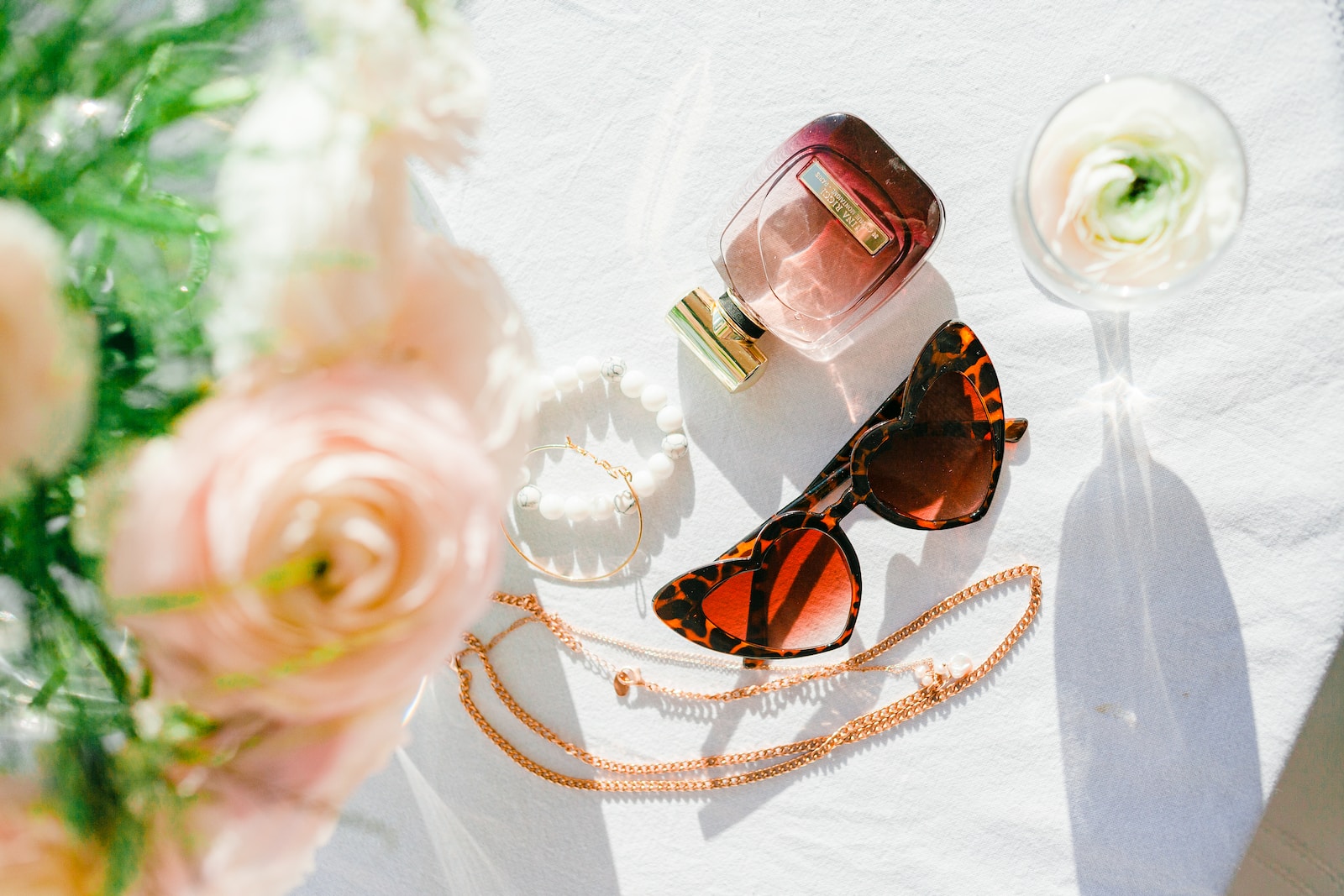 brown sunglasses on white textile