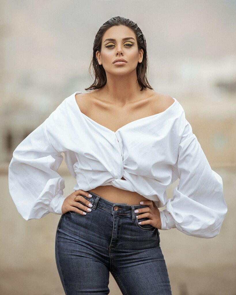 woman in white long sleeve shirt and blue denim jeans