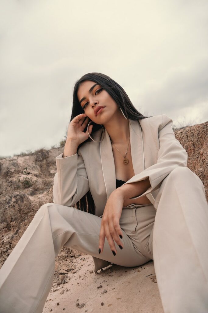 Elegant Woman in a Beige Suit Posing on Sand