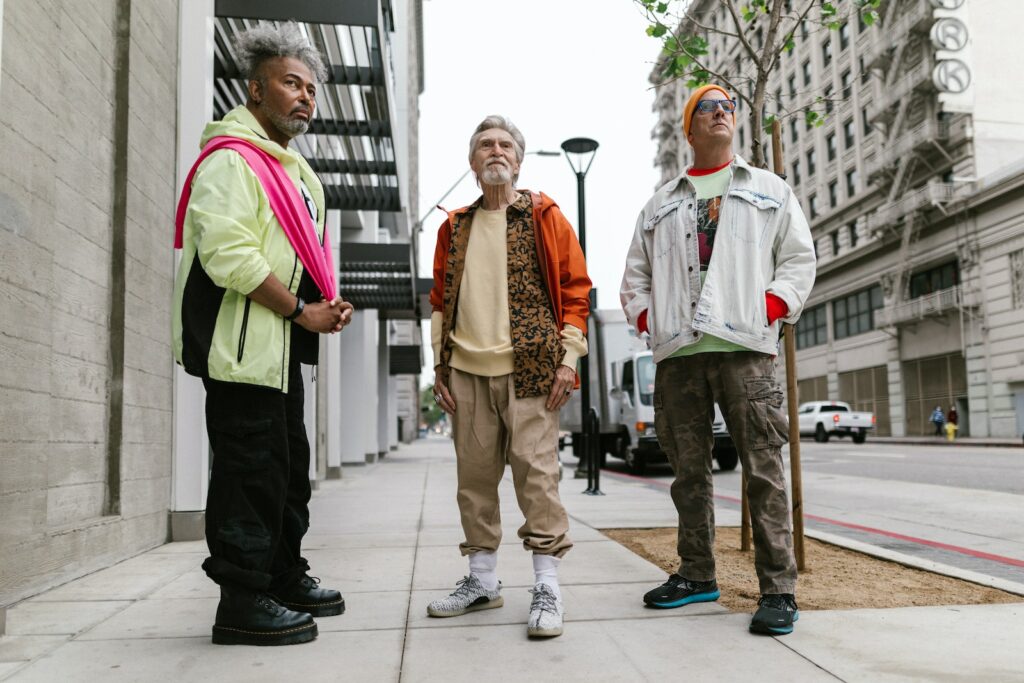 A Group of Elderly Men Standing on the Street while Wearing Stylish Clothes