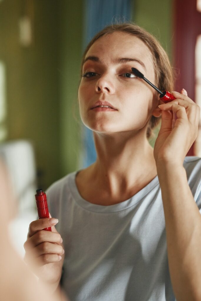 Pretty Woman Applying Mascara on Eye Lashes