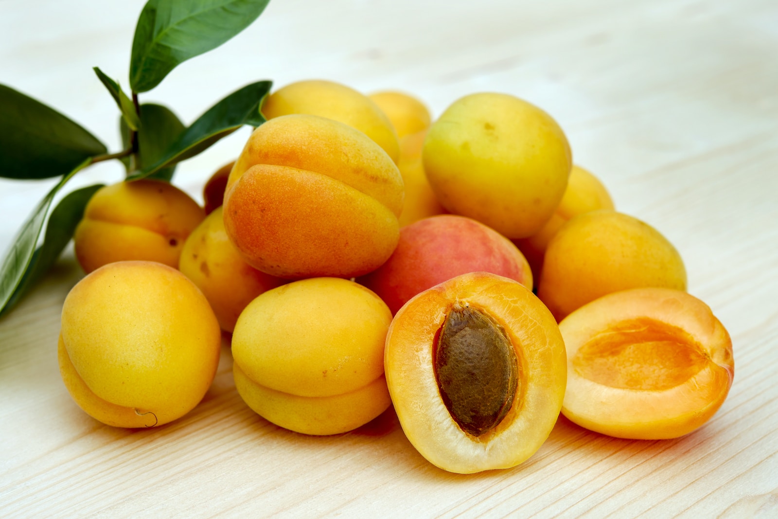 yellow round fruits on white table