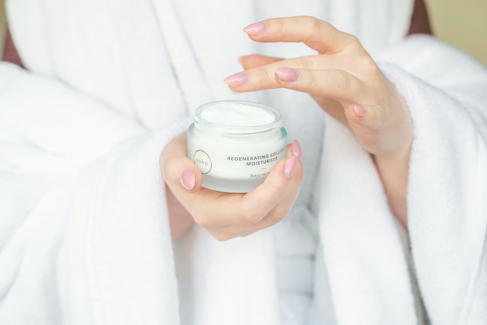 person holding white plastic container