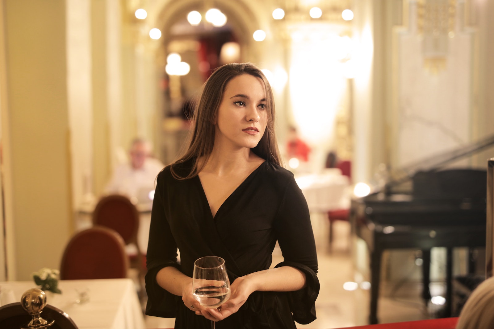 Woman in Black Long Sleeve Holding Champagne Glass