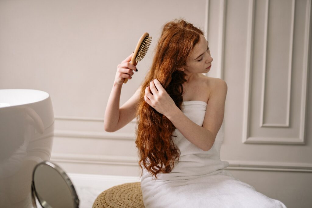 Woman in White Bath Towel Holding Brown Hair Brush