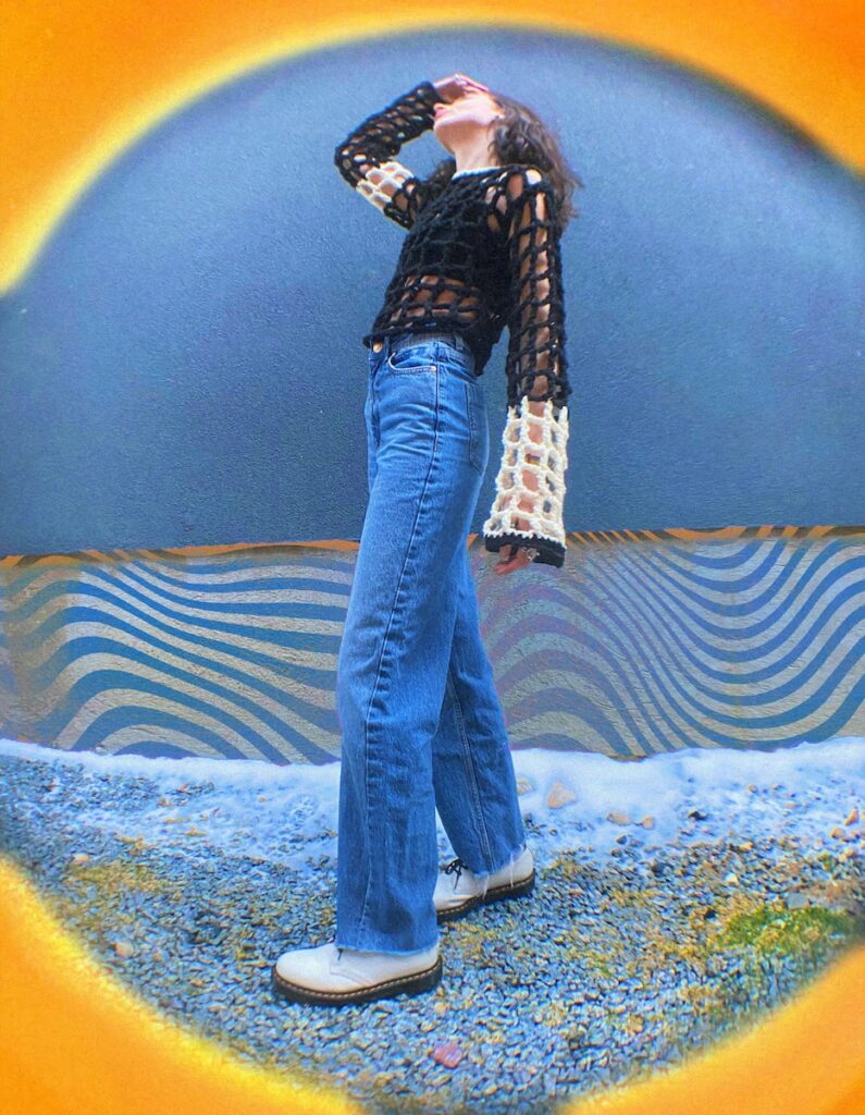 a woman standing in front of a blue wall