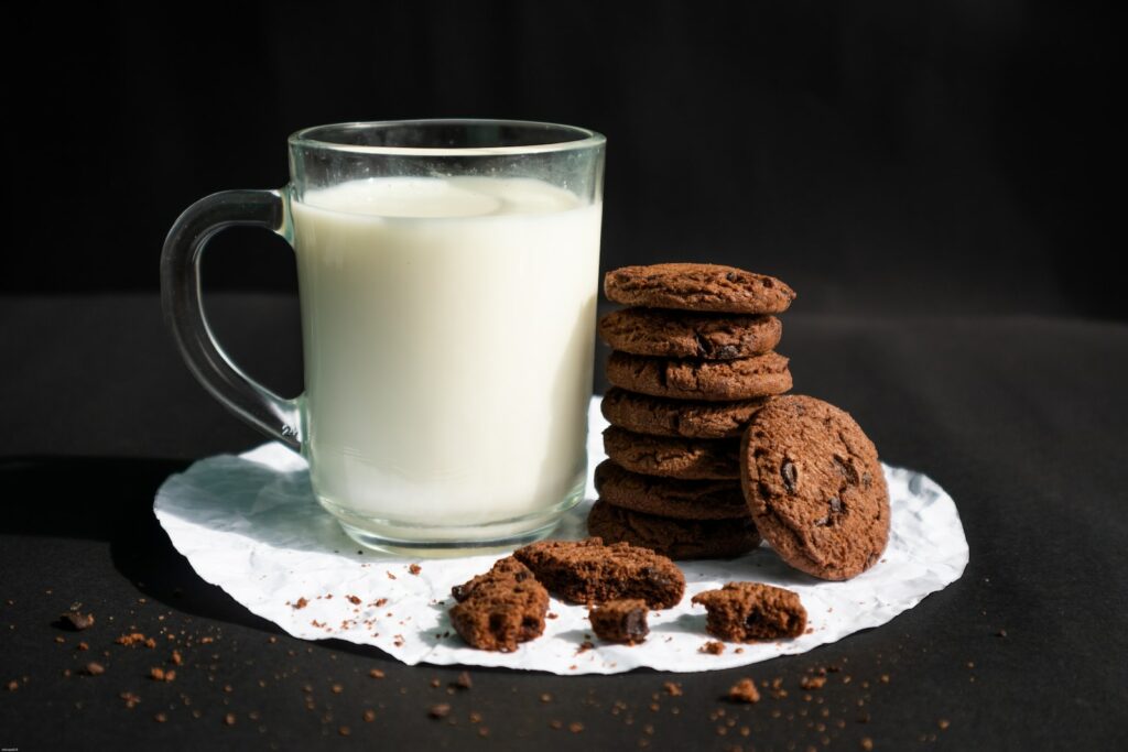 cookies and milk in clear glass mug