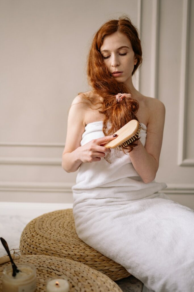 Woman in White Bath Towe Brushing her Hair