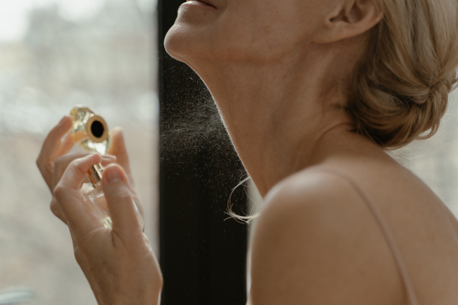 A Woman Spraying Perfume