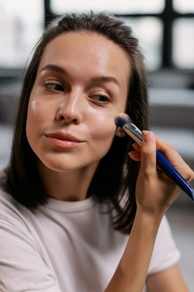 Woman in White Shirt Applying Makeup