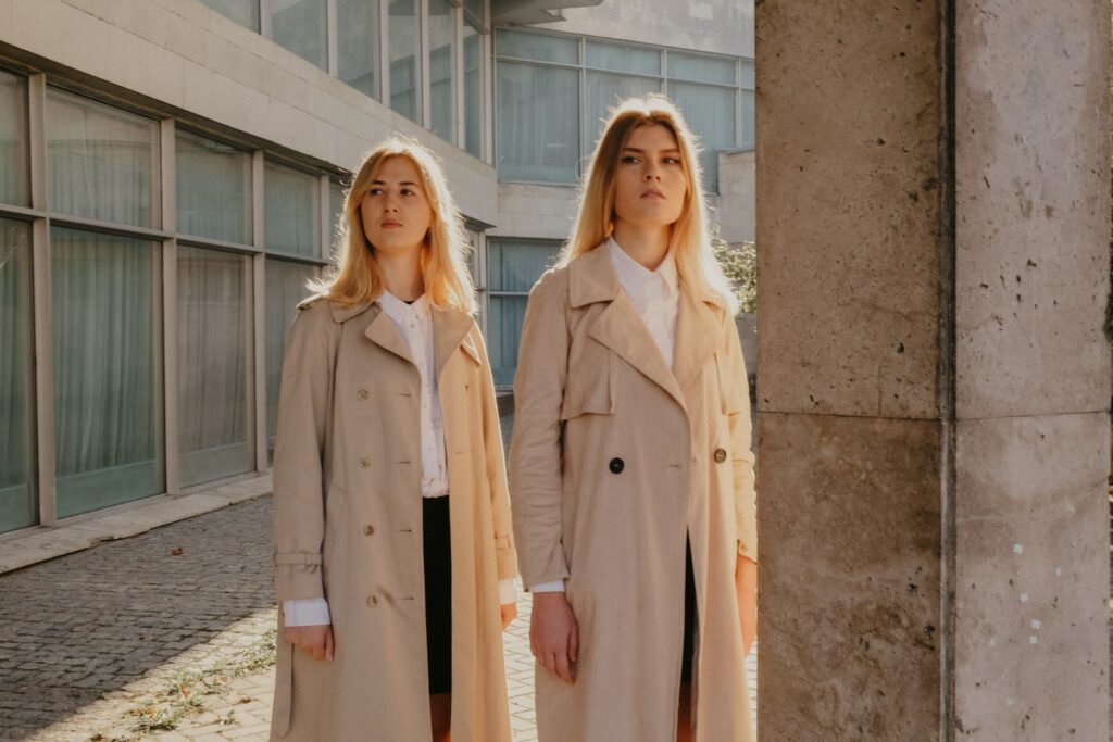 two woman wearing brown coat