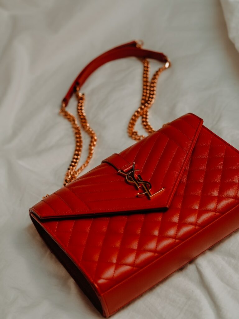 red leather flip case on white textile