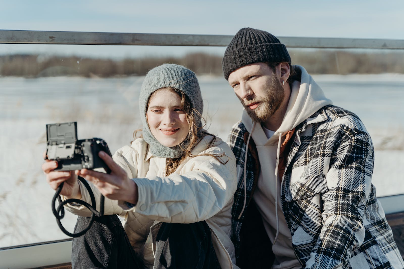 A Couple Taking Photo while Wearing Knitted Cap