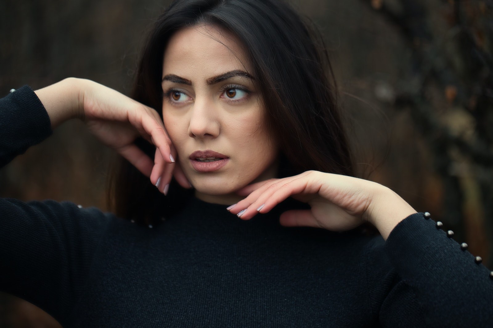 a woman in a black sweater posing for a picture