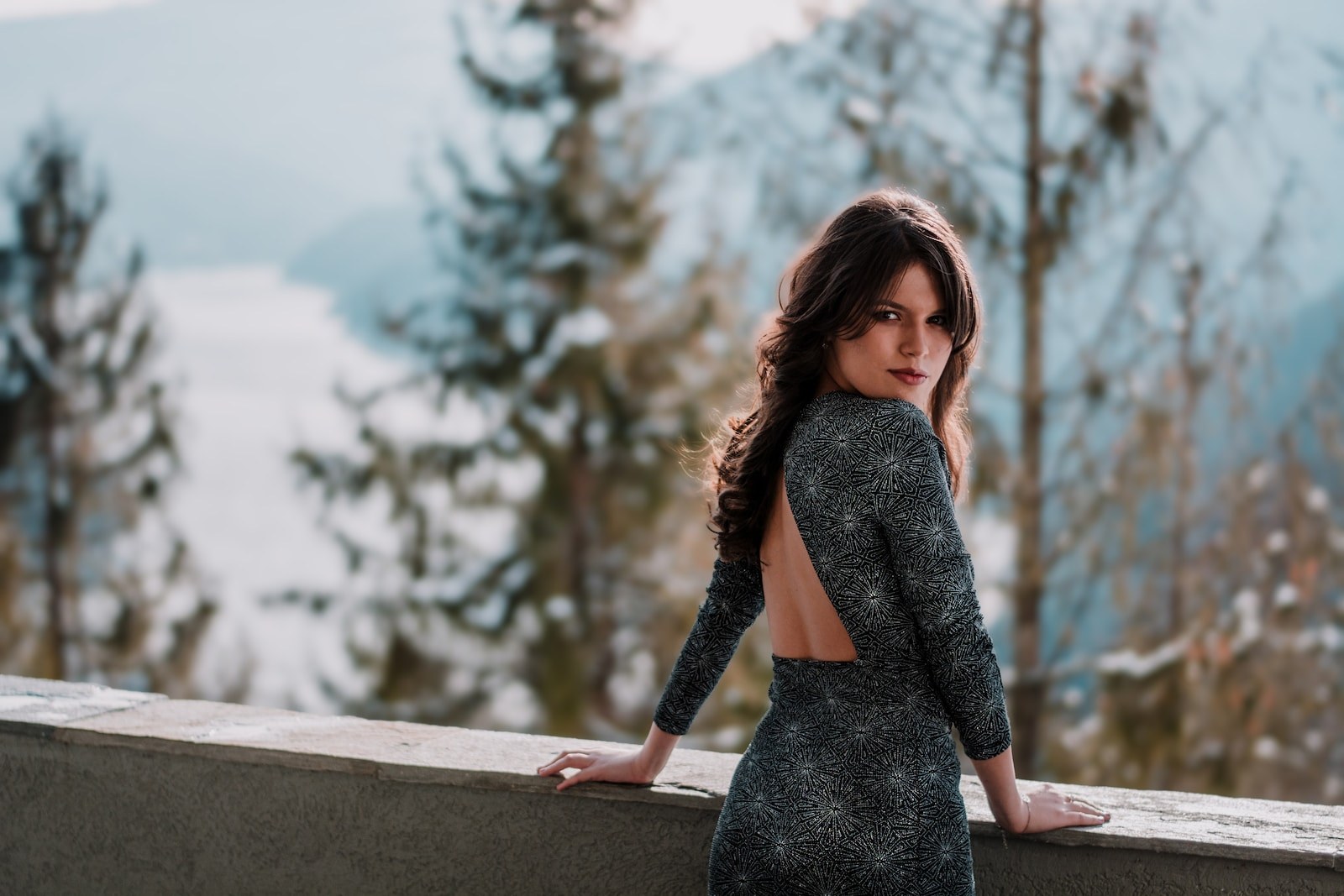 woman standing in front of gray concrete ledge