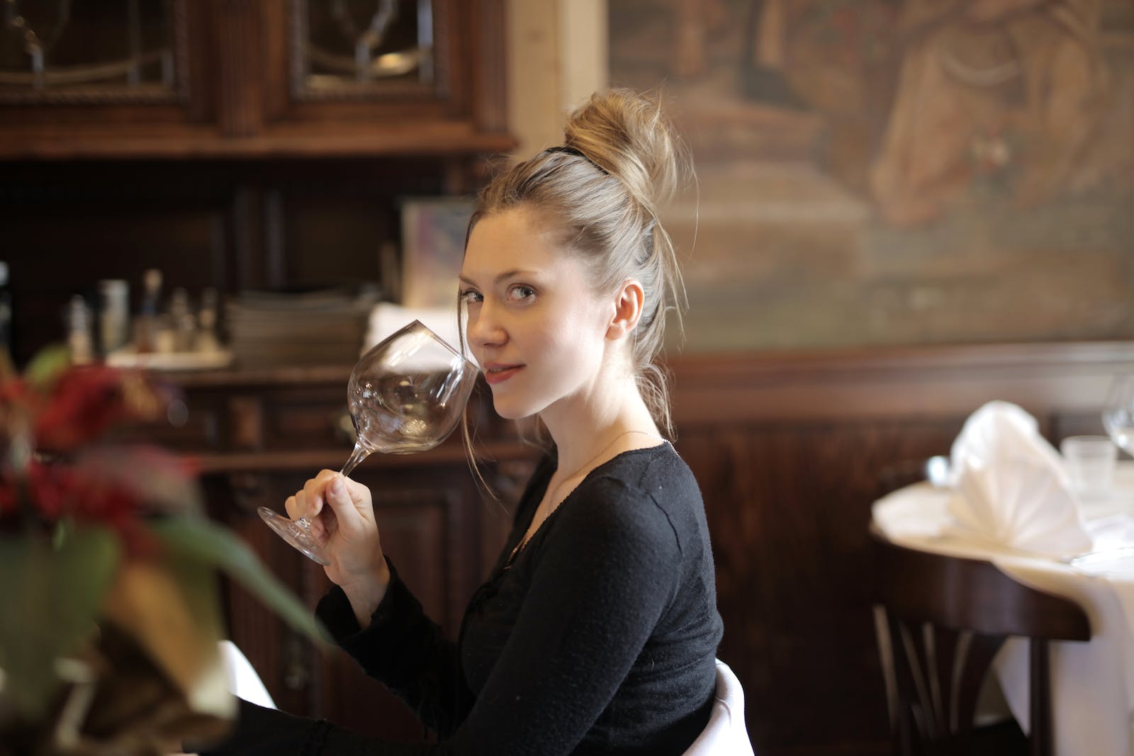 Blond Hair Woman in Black Long Sleeves Holding Wine Glass