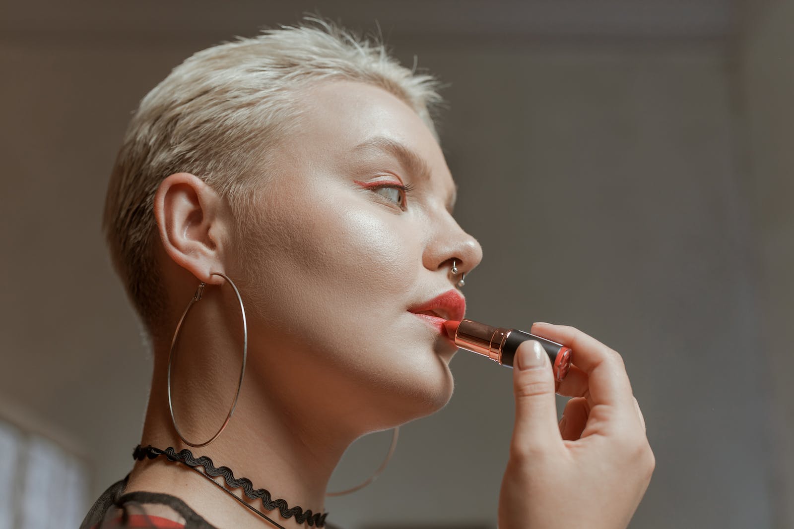 Woman Putting on a Red Lipstick