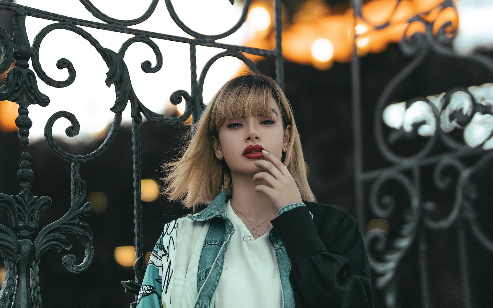 Portrait of Blond Woman Against Gate