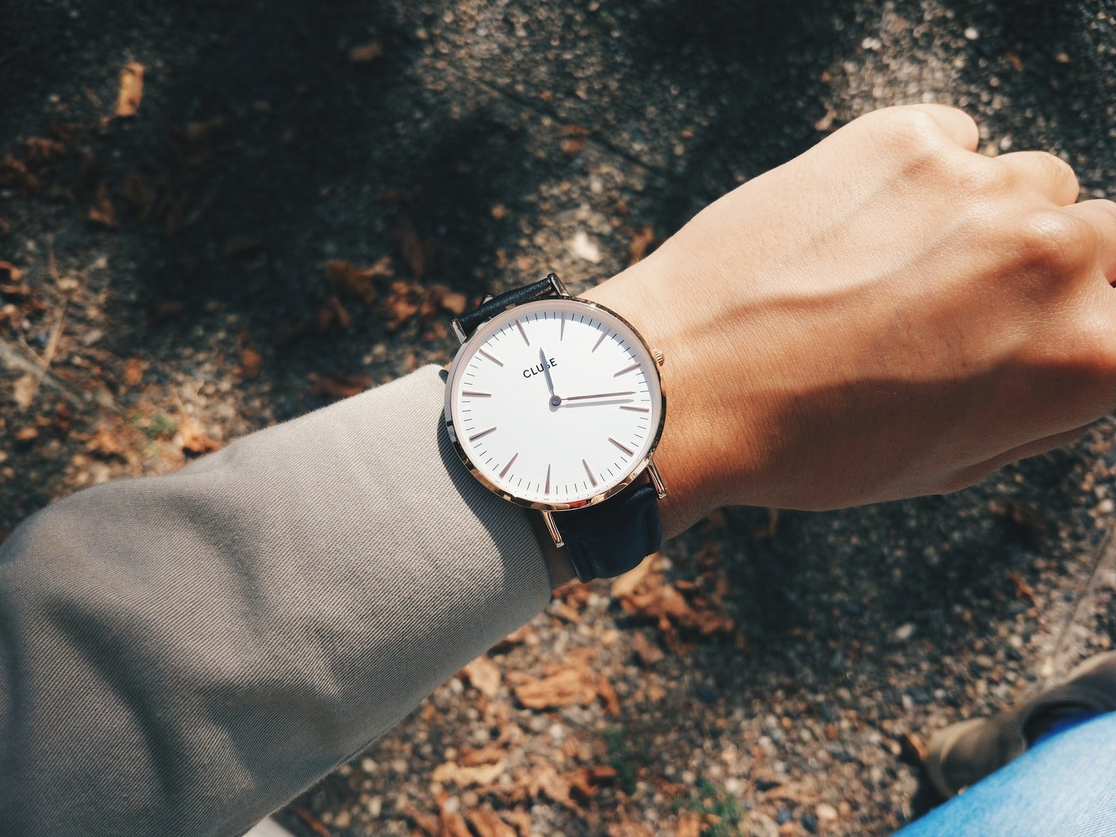 person wearing round silver-colored analog watch at 1:19