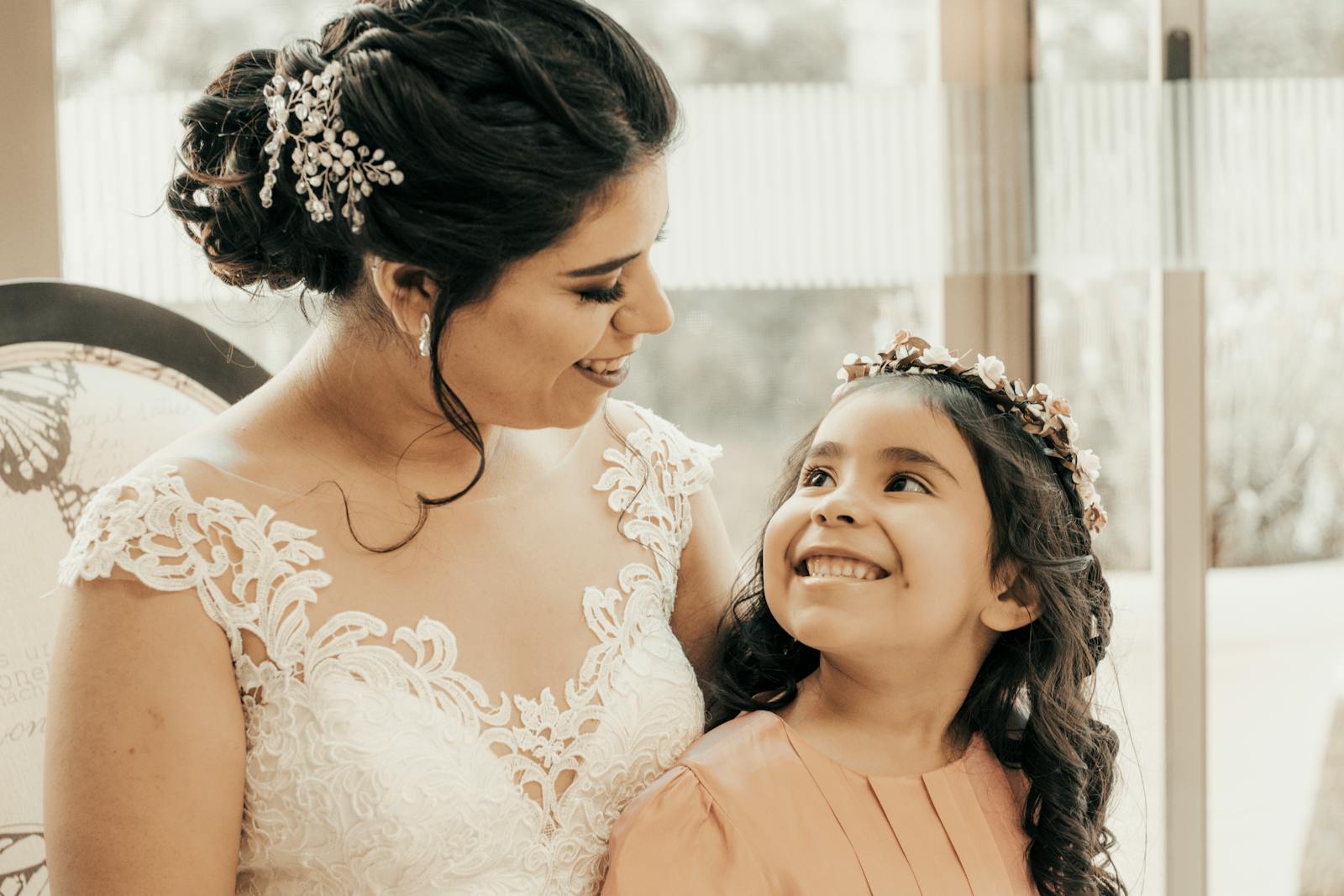 A Beautiful Bride Smiling while Looking at Her Daughter