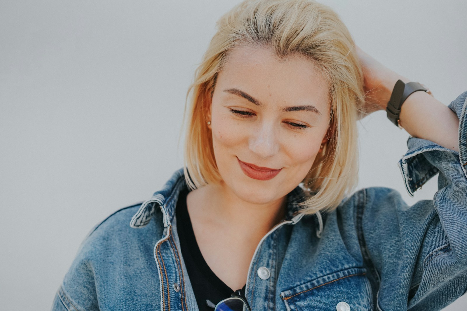 woman in blue denim jacket smiling