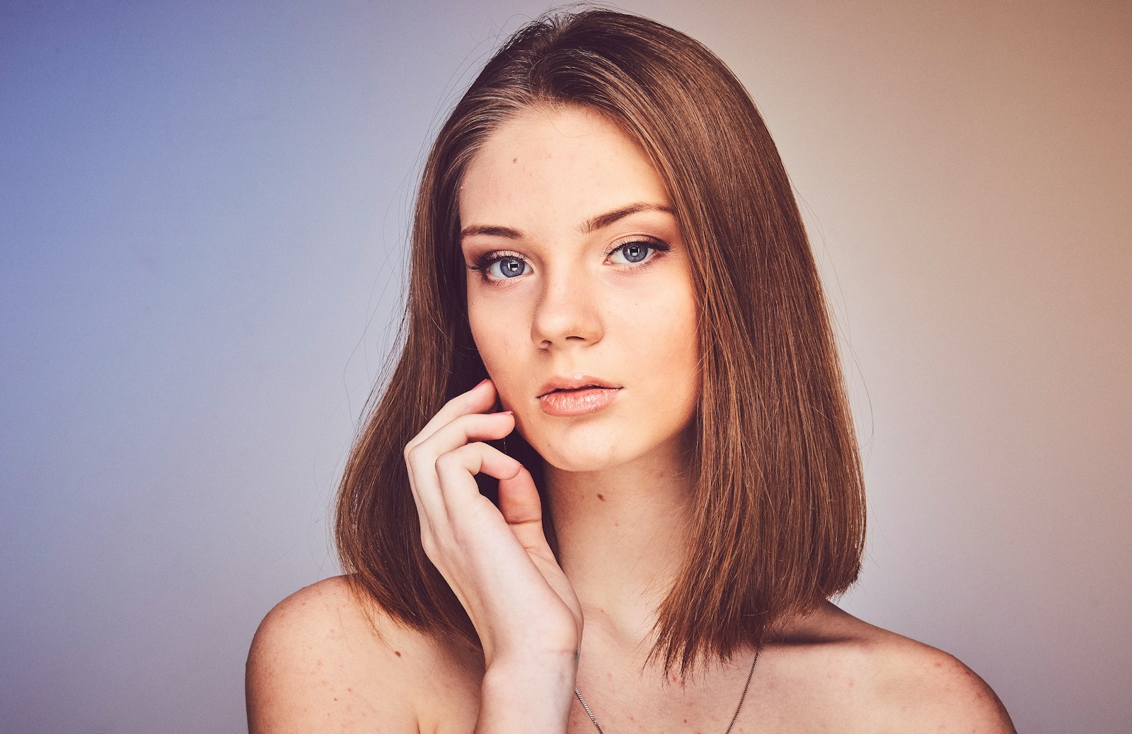 woman with her hand on cheek