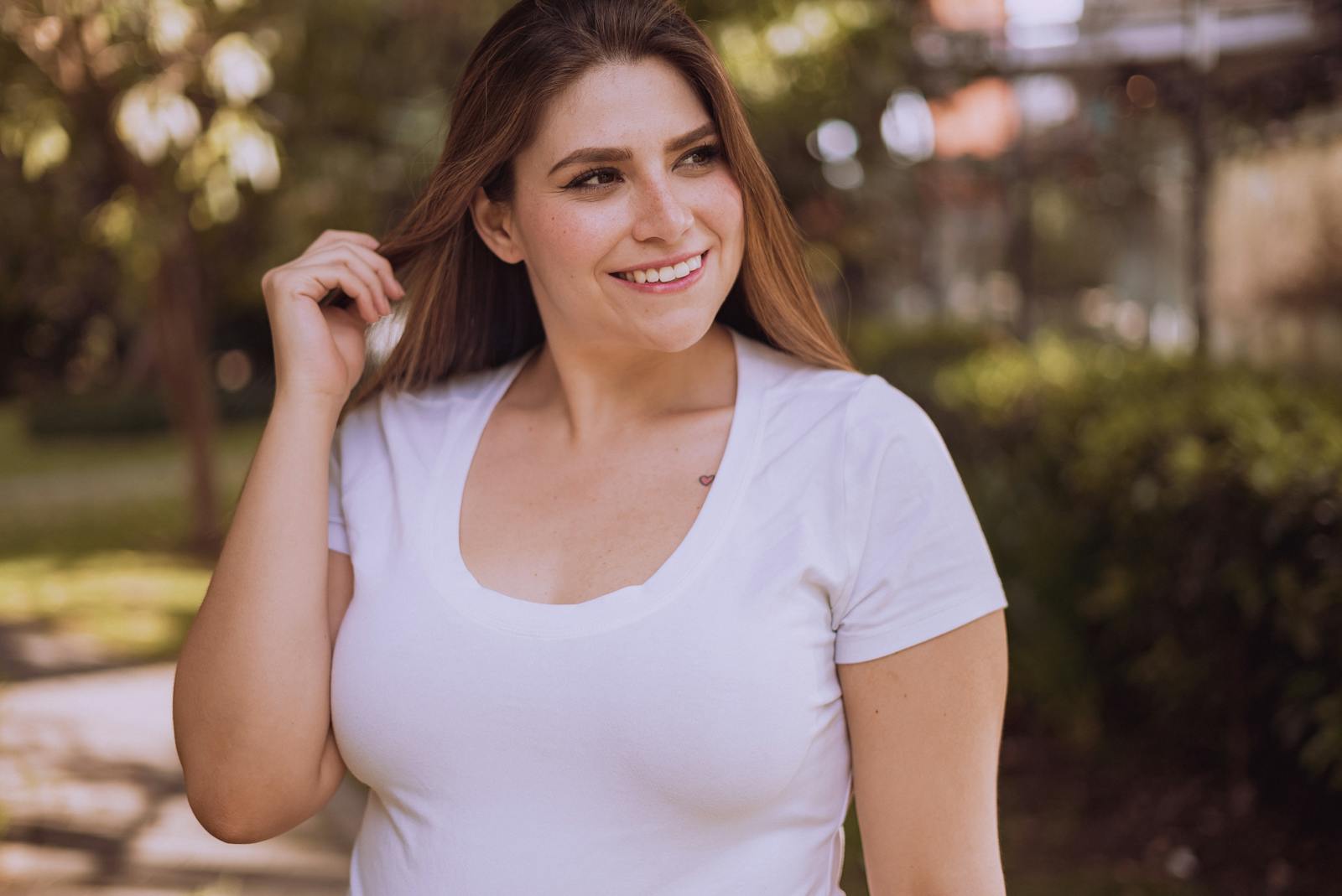 A Smiling Woman Wearing a White Shirt