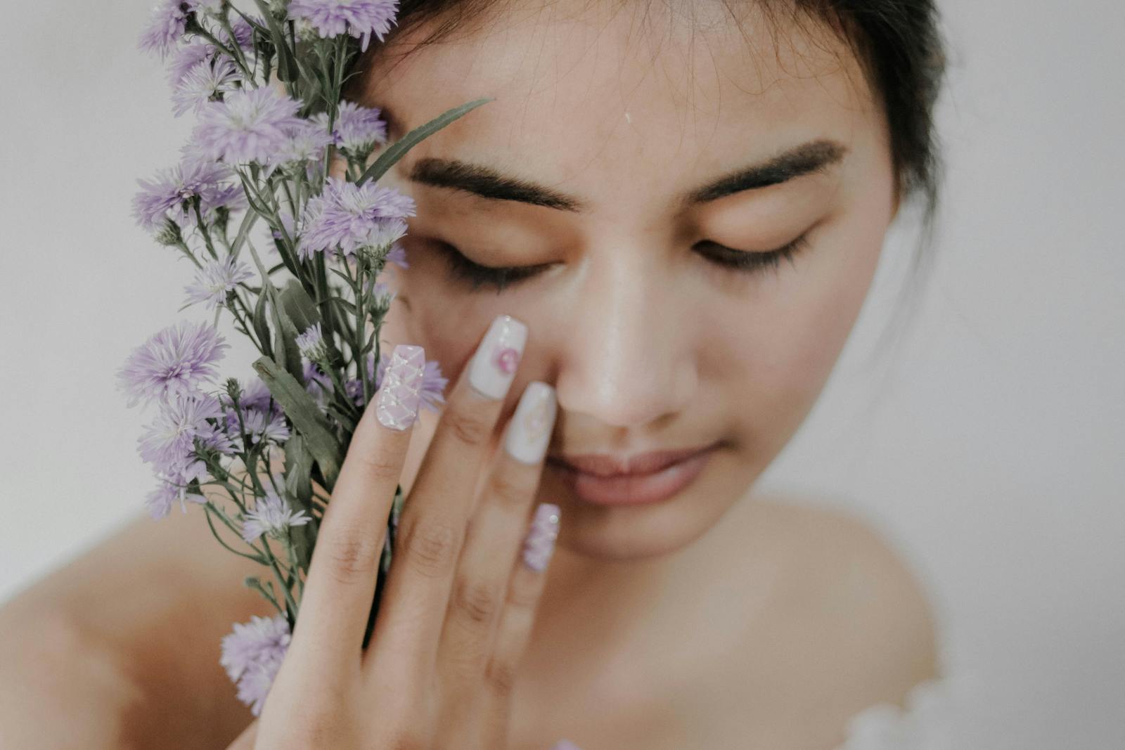 Woman Holding Purple Petaled Flowers