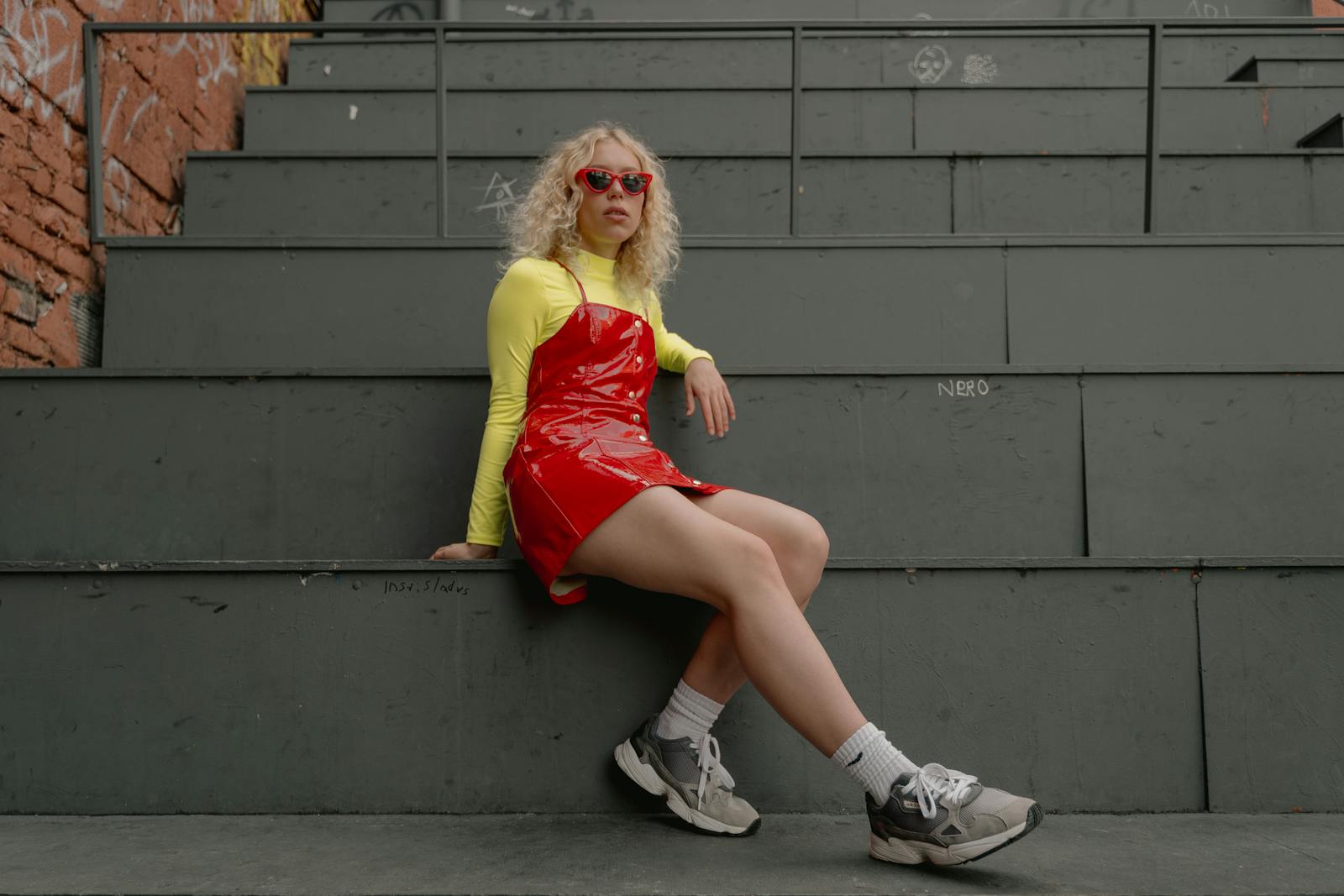 Woman Wearing Red Leather Dress Sitting on Stairs