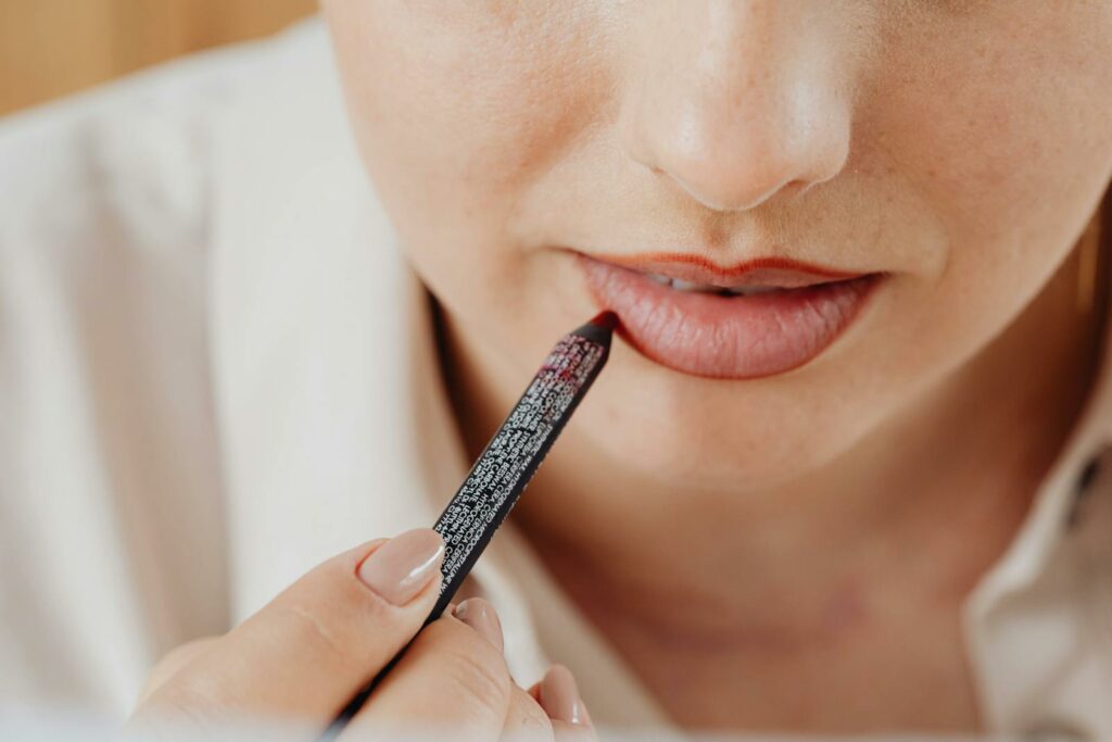 A Person Applying Lip Liner