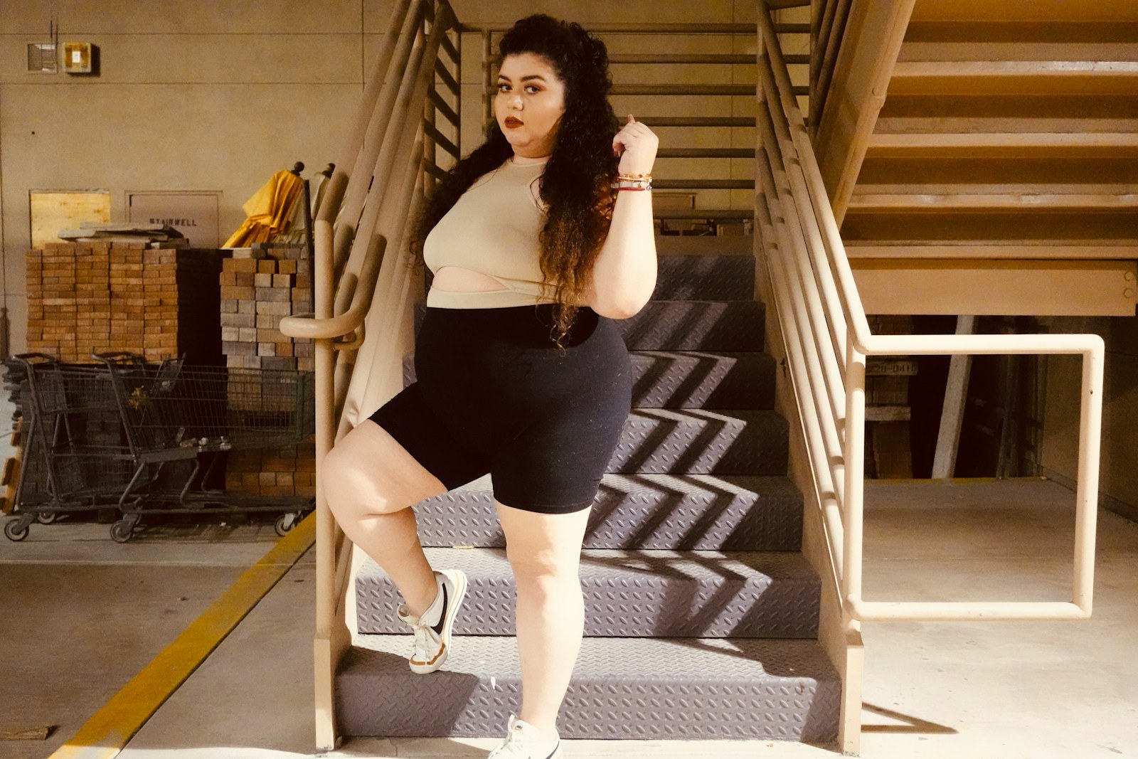 a woman in a short skirt is standing on the stairs