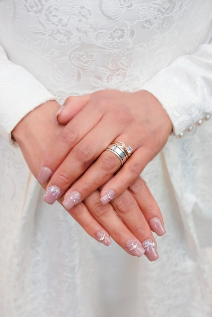 woman wearing silver ring and white floral lace dress