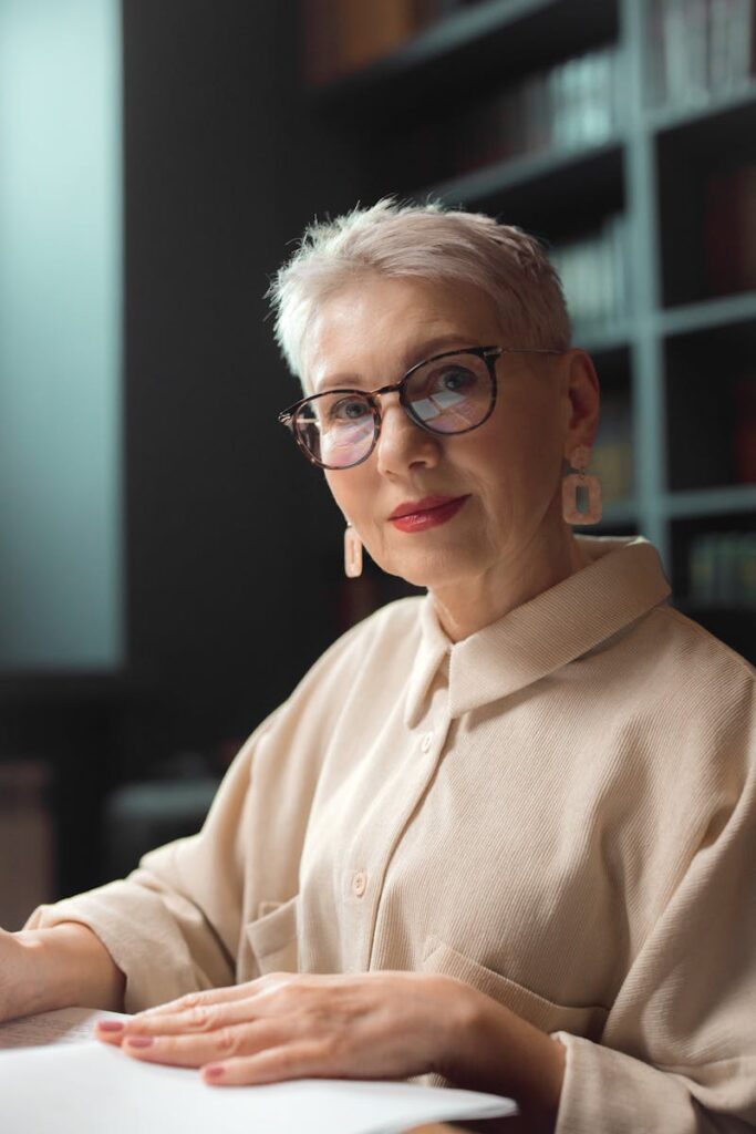 An Elderly Woman Wearing Brown Long Sleeves and Eyeglasses