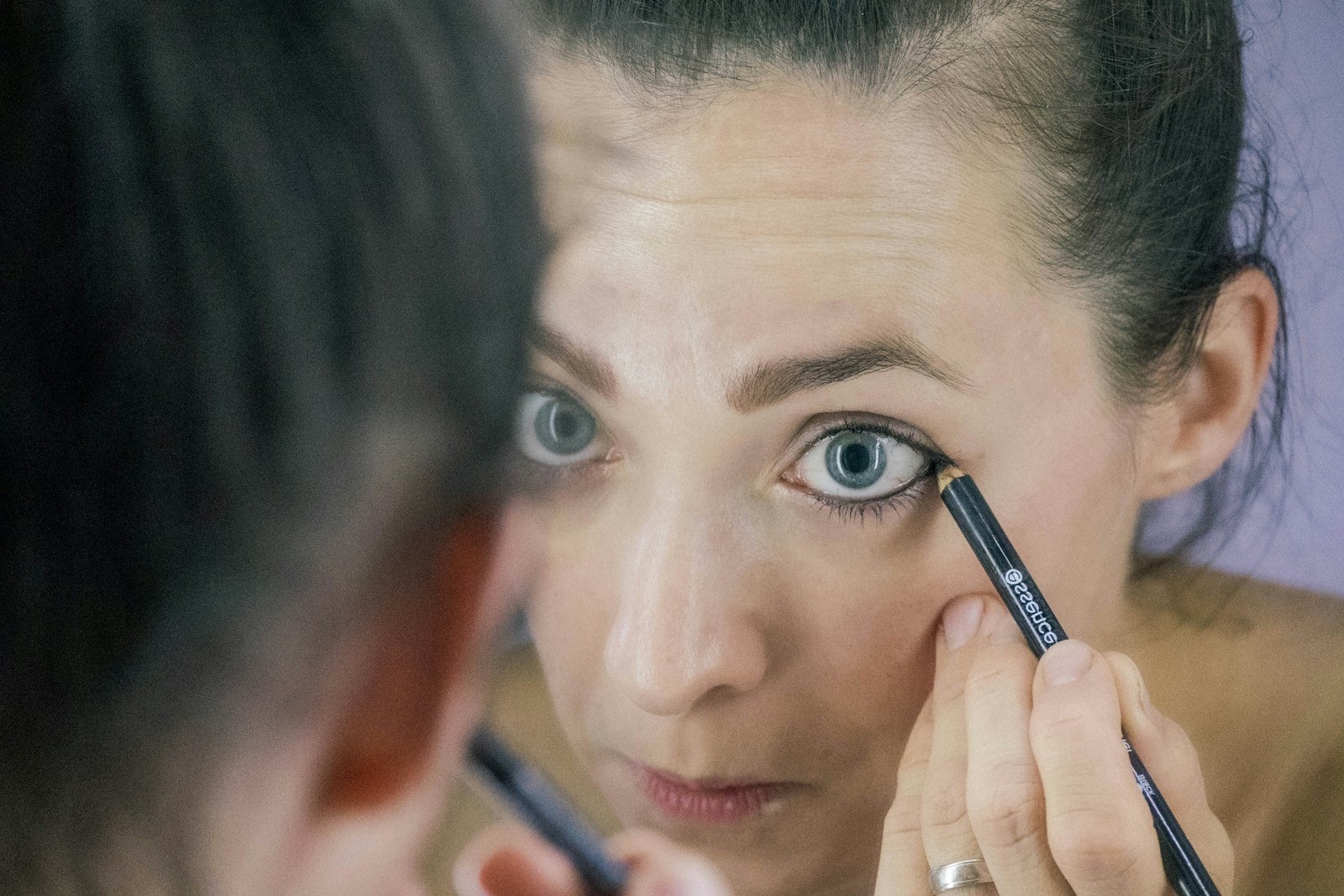 a woman is looking at her reflection in the mirror